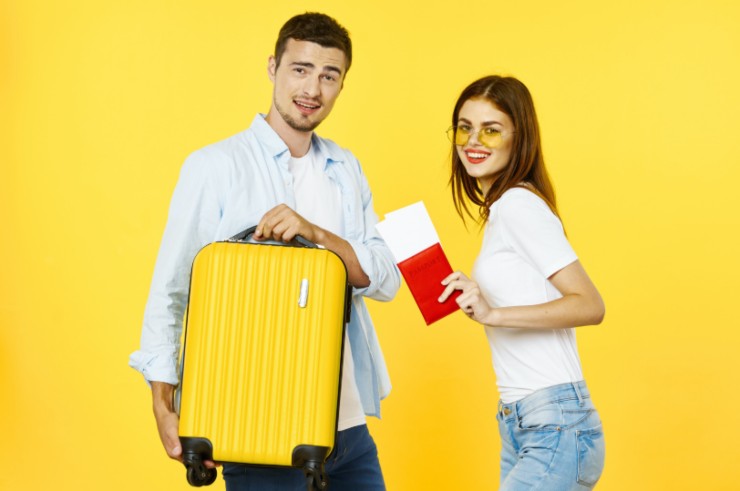 uomo e donna con valigia e passaporto